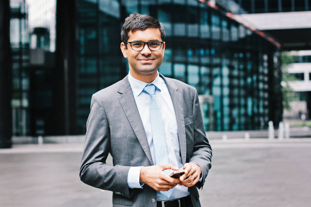 Skilled professional smiling confidently after receiving the Skilled Independent Visa Subclass 189 permanent visa through the points system in Australia
