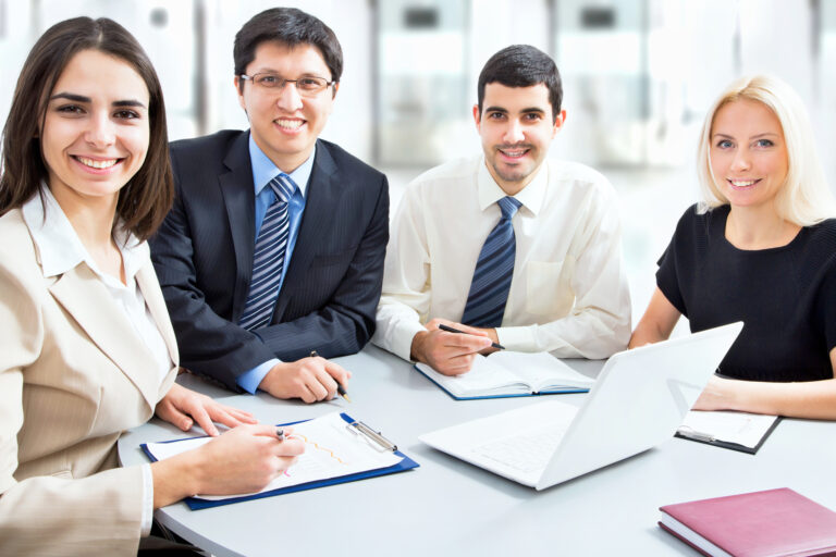 About us team at Better Life Migration meeting with clients in a professional office setting