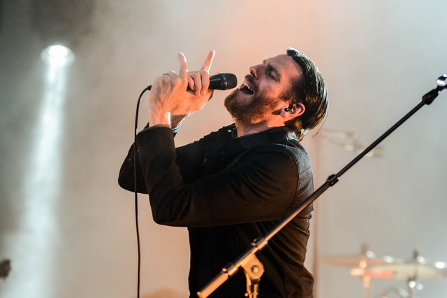 Performer singing on stage during a live concert – Temporary Activity Visa 408 Australia