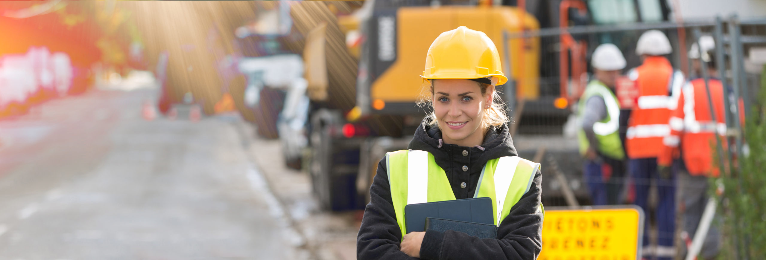 panoramic view of young female architect with construction team