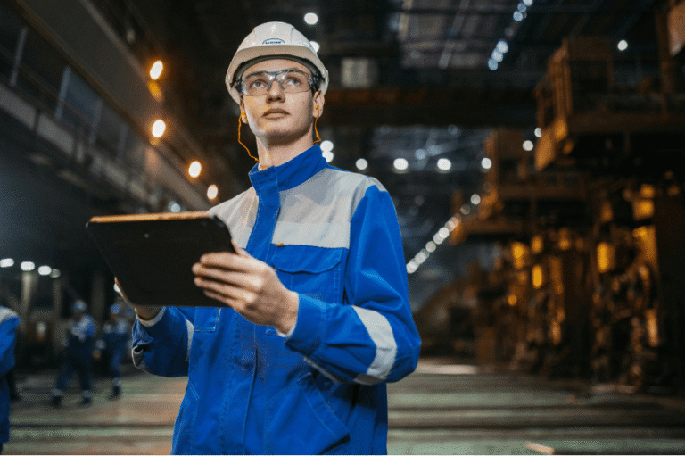 Worker in safety gear using tablet